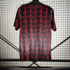 24/25 Manchester United Away Pre-Match Training Jersey - Black-Red with Geometric Arrow Pattern & Tezos Sponsor