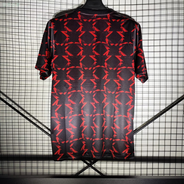24/25 Manchester United Away Pre-Match Training Jersey - Black-Red with Geometric Arrow Pattern & Tezos Sponsor