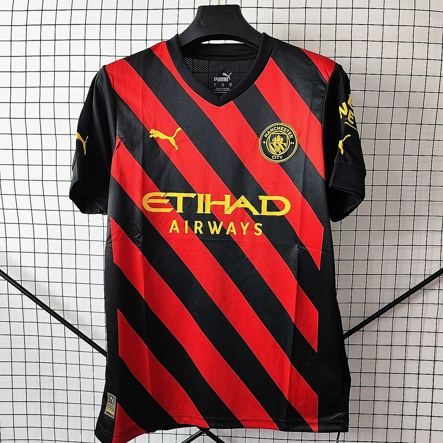 22/23 Manchester City Away Jersey - Black-Red Diagonal Stripes with Gold Accents & Bold Color-Block