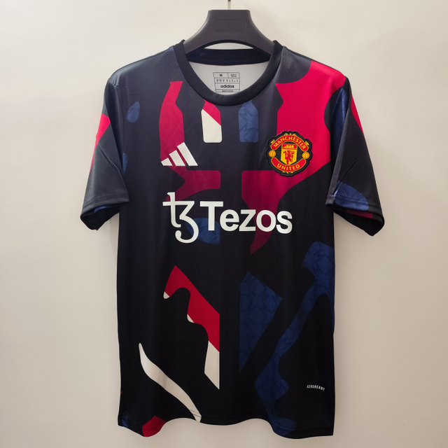 24/25 Manchester United Training Jersey - Black with Red-Blue-White Geometric Pattern & White Accents