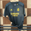 23/24 Real Madrid Second Away Jersey - Matte Black with Gold Accents & Henley Collar