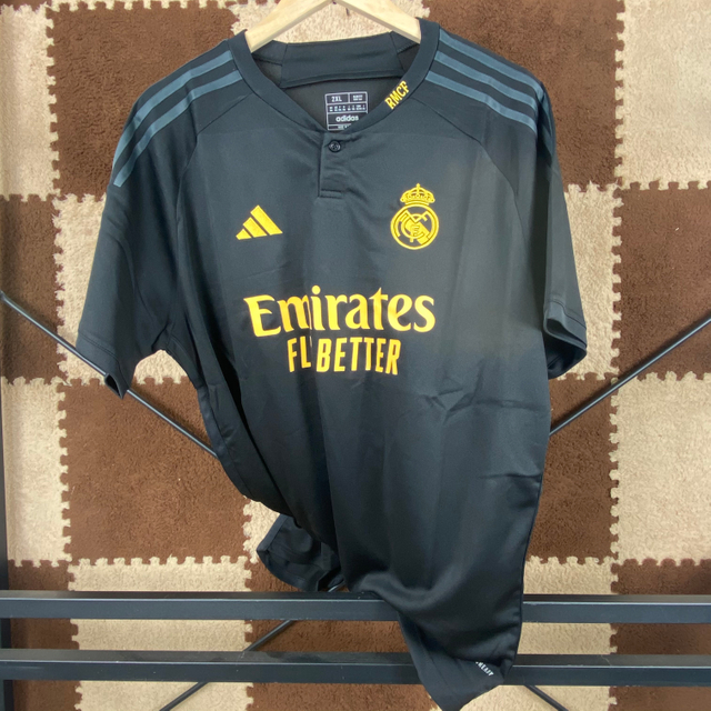23/24 Real Madrid Second Away Jersey - Matte Black with Gold Accents & Henley Collar