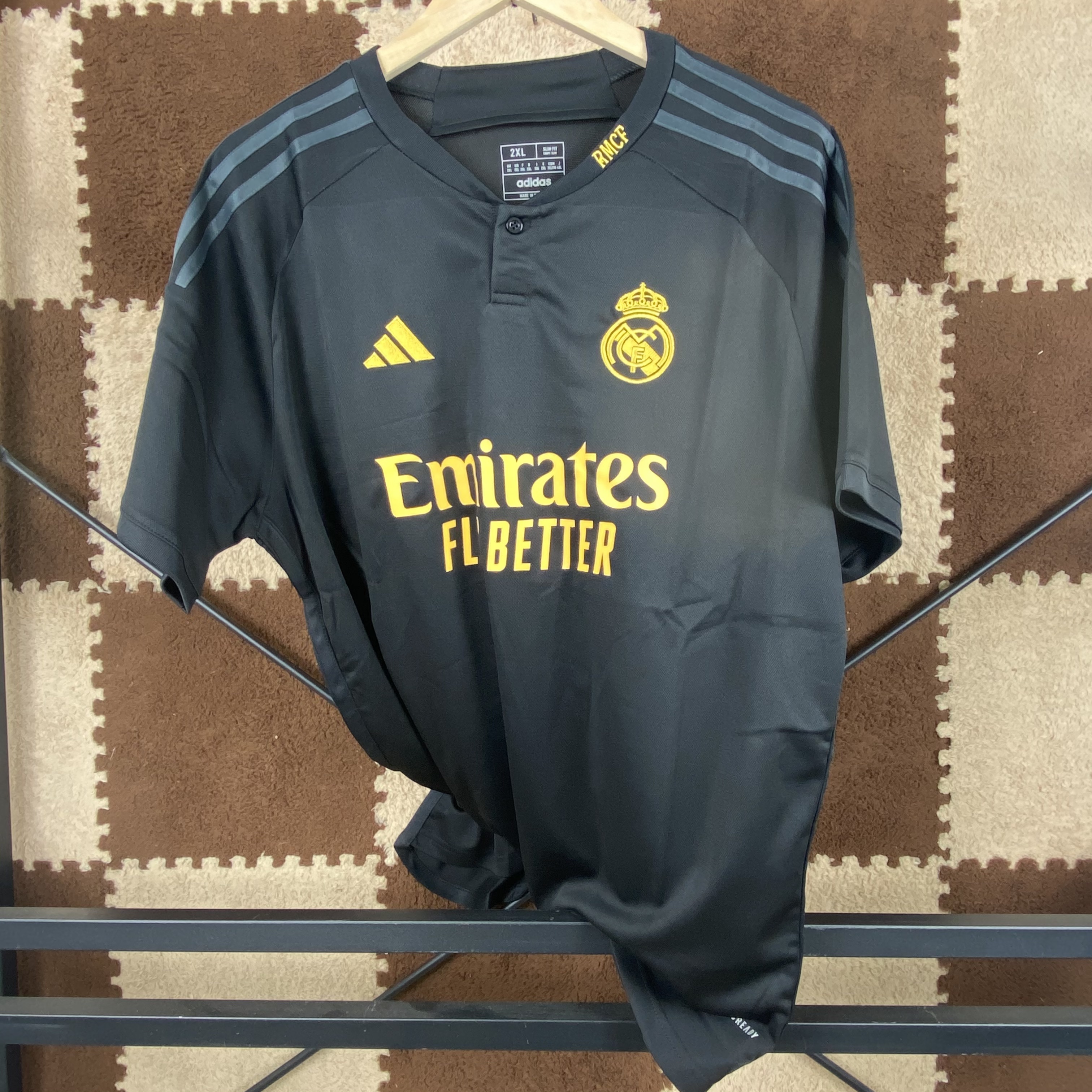 23/24 Real Madrid Second Away Jersey - Matte Black with Gold Accents & Henley Collar