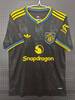 25/26 Manchester United Second Away Jersey - Black with Yellow-Blue Accents & Retro Trefoil Logo