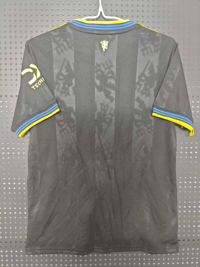 25/26 Manchester United Second Away Jersey - Black with Yellow-Blue Accents & Retro Trefoil Logo