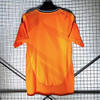 24/25 Real Madrid Away Jersey - Bright Orange with Dark Pattern & Navy Accents